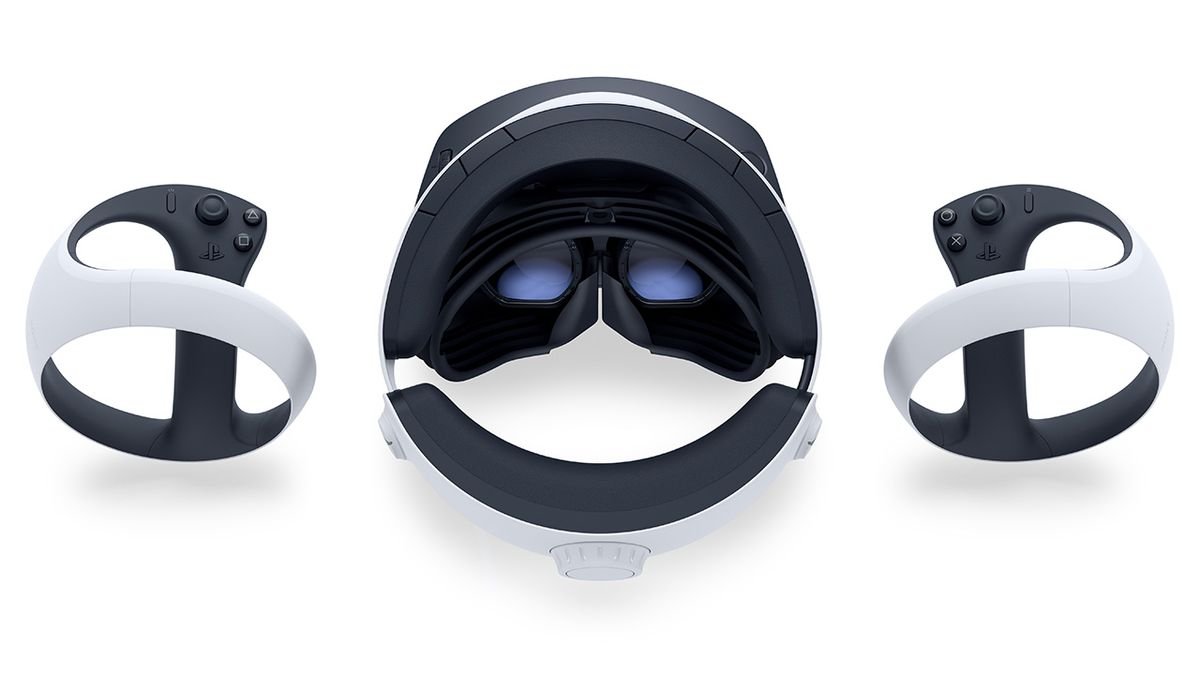 The PSVR 2 headset, as seen from above, resting on a white surface, flanked by both VR2 Sense controllers