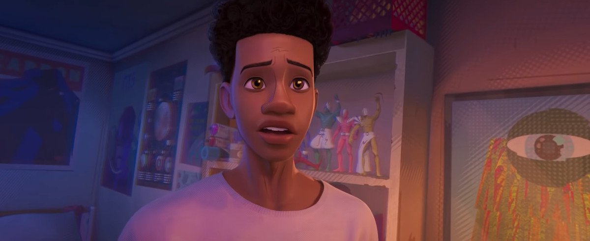 miles morales in across the spider-verse in spider-man. he’s looking at gwen stacy and look a little surprised and nervous.