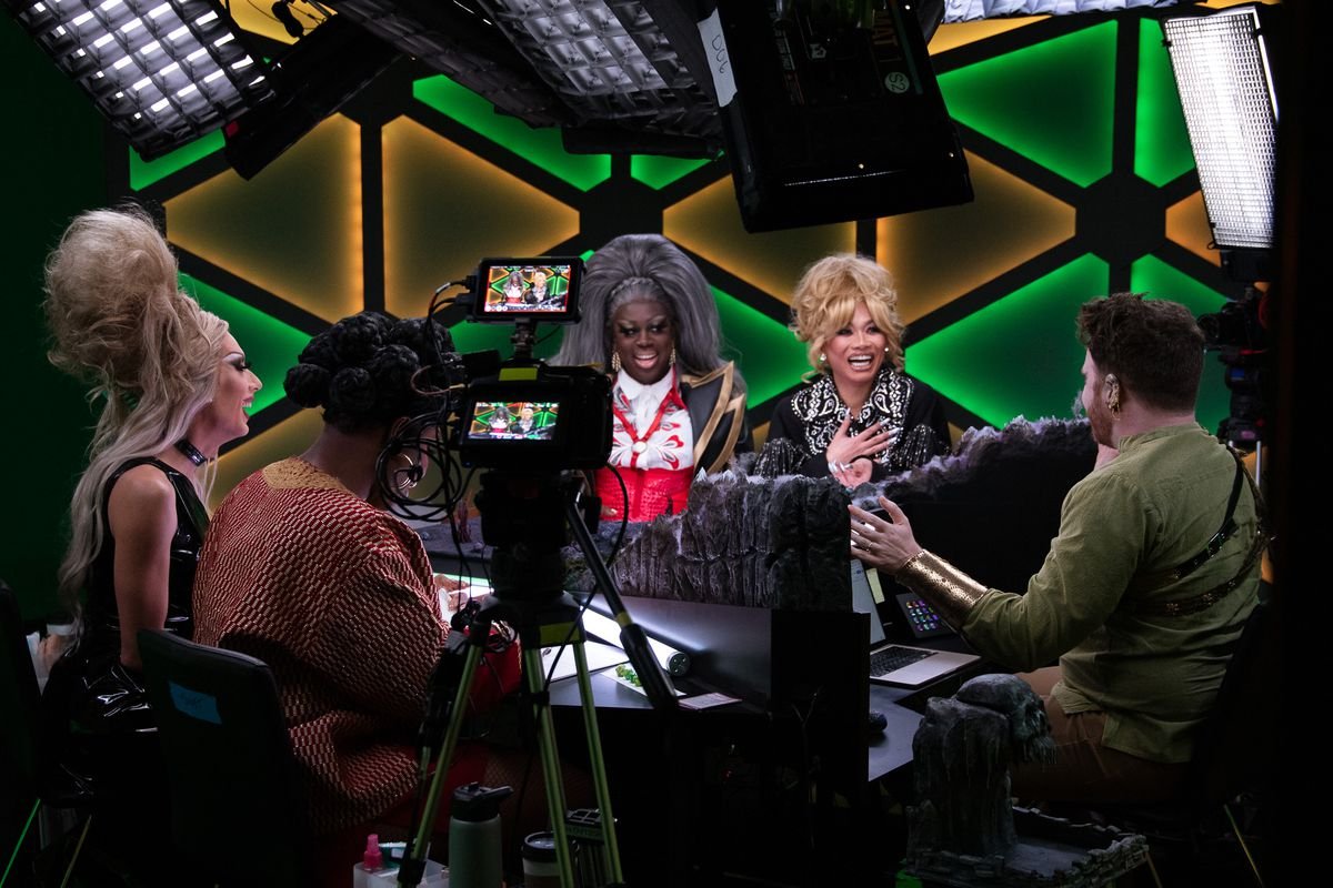 The full cast of Dungeons and Drag Queens — including Jujubee, Monet X Change, Alaska Thunderfuck, and Bob the Drag Queen. Dungeon Master Brennan Lee Mulligan sits with his back to the camera.
