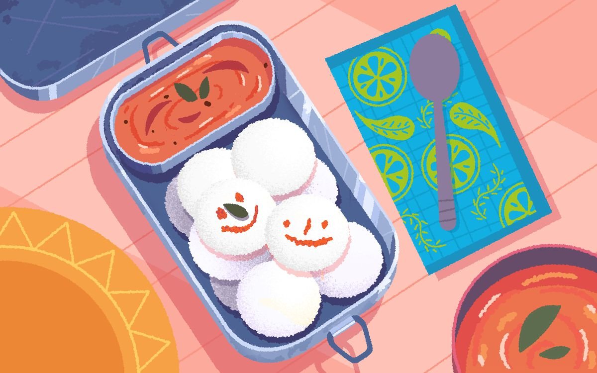 Steamed rice cake in a box, with two smiley faces painted on with sauce