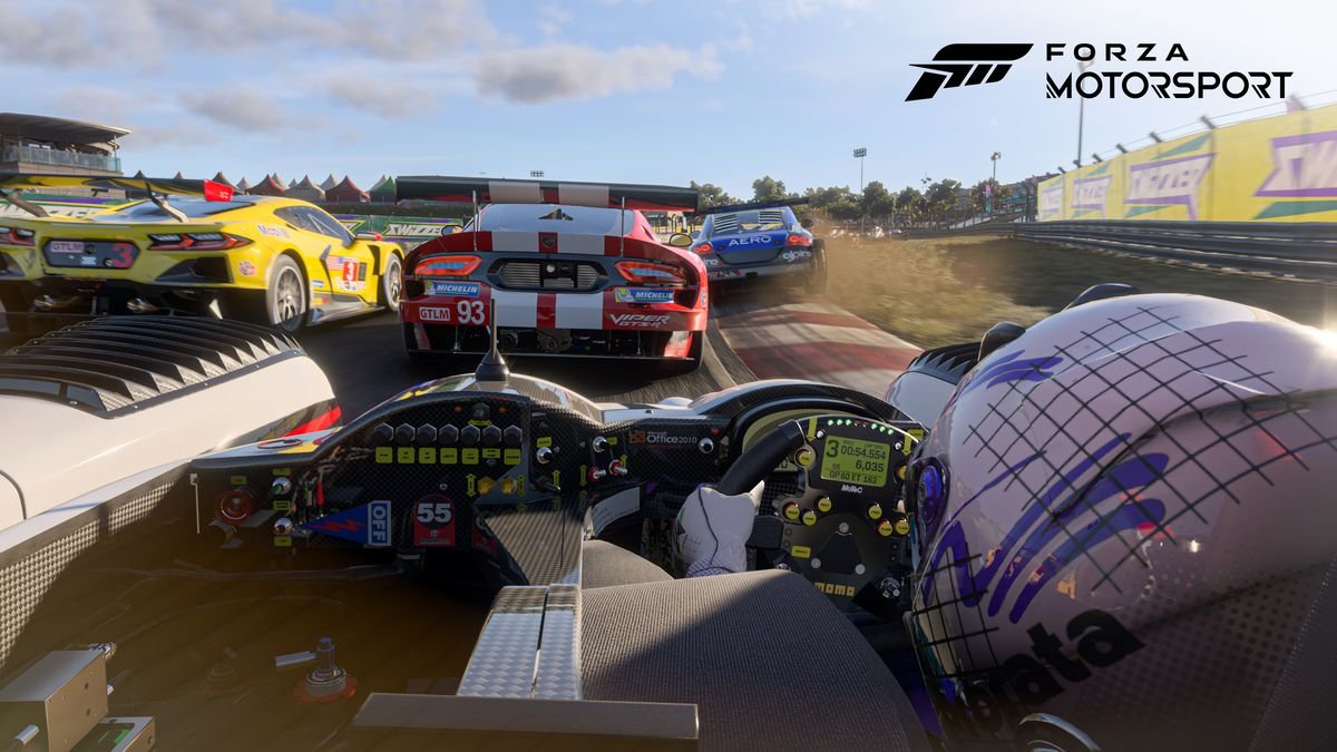 A view over the driver’s should in an open-cockpit racing car as ir races closely with other cars
