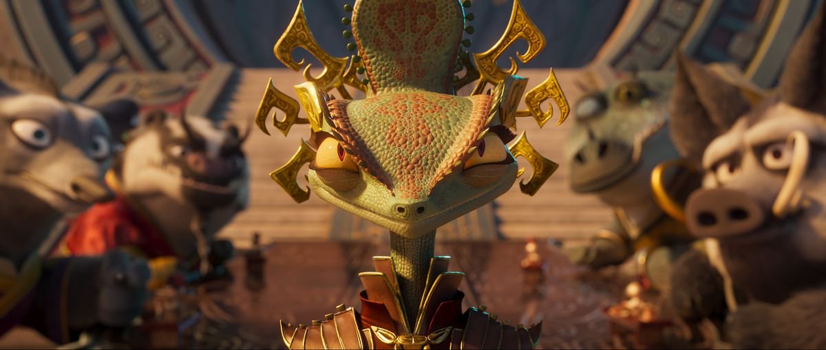 A tiny chameleon wearing an elaborate gown and headpiece looks angry