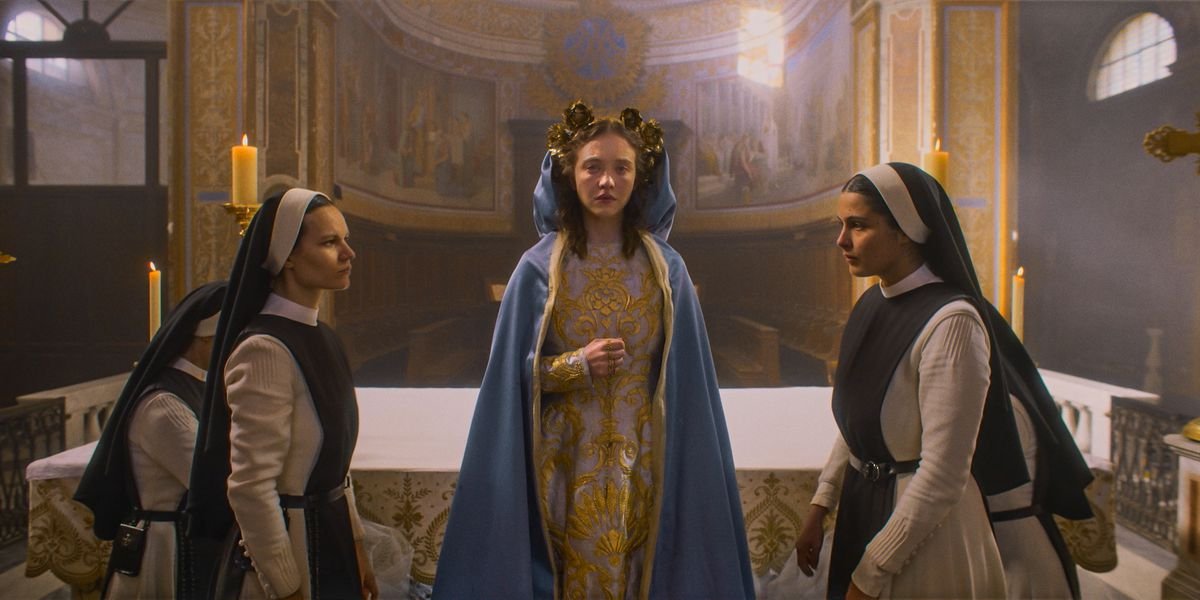 Sydney Sweeney in Immaculate dressed like Mary with nuns flanking her on either side